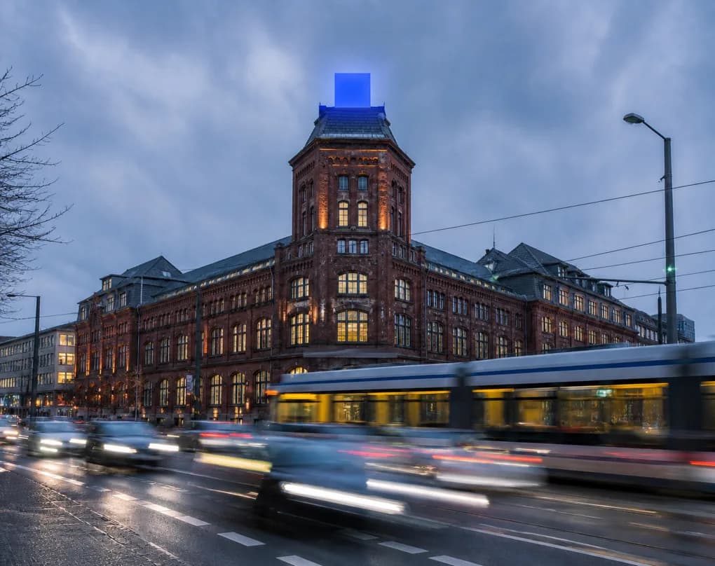 An illuminated city building at dusk